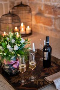 a table with two wine glasses and a bottle of wine at New Dimora Valmar in Polignano a Mare