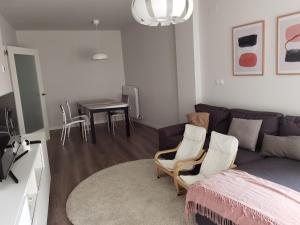 a living room with a couch and chairs and a table at Apartamento Palacio de los Toledo in Corella
