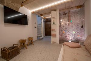 een woonkamer met een bank en een tv bij Dimora Valmar Luxury Charm in Polignano a Mare