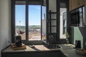 a kitchen with a sink and a window with a view at La Cúpula in Córdoba