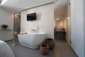 a bathroom with a white tub and a sink at New Dimora Valmar in Polignano a Mare