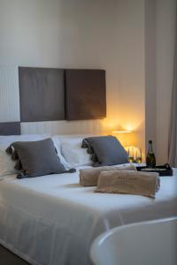 a large white bed with two pillows on it at New Dimora Valmar in Polignano a Mare