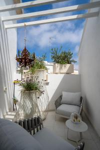 a balcony with two chairs and a chandelier at New Dimora Valmar in Polignano a Mare
