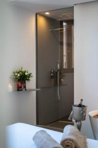 a bathroom with a shower with a mirror at New Dimora Valmar in Polignano a Mare