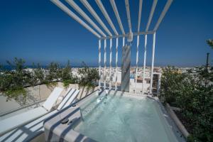 a hot tub on a balcony with a view of the beach at New Dimora Valmar in Polignano a Mare