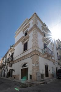 a white building with the sun shining on it at New Dimora Valmar in Polignano a Mare