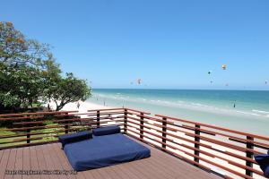 a blue bed sitting on top of a wooden fence next to the beach at E303 Baan Sanpluem Hua Hin By Pat in Hua Hin