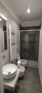 a bathroom with a toilet and a sink and a shower at Vien dal Mare in Bari