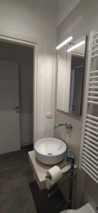 a bathroom with a white sink and a mirror at Vien dal Mare in Bari +11 photos