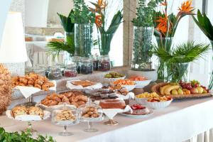 a buffet with many different types of food on a table at Due Lune Puntaldia Resort & Golf in San Teodoro