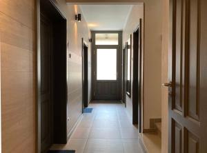 a hallway with a door and a tile floor at Toronyi Vendégház in Torony