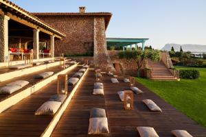 a row of pillows sitting on a wooden deck at Due Lune Puntaldia Resort & Golf in San Teodoro