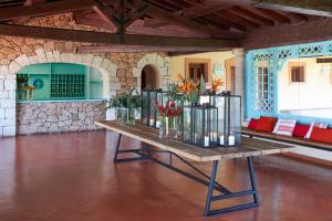 a table with vases of flowers on it in a room at Due Lune Puntaldia Resort & Golf in San Teodoro