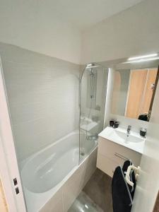 a bathroom with a shower and a tub and a sink at #902 MARINA RIVIERA BAY - Marina Baie des Anges in Villeneuve-Loubet