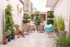 an outdoor patio with chairs and plants at Beautiful Super Modern Gigantic Designer Home in Bangkok