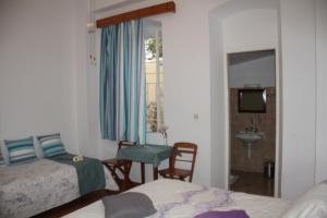 A bed or beds in a room at Medieval Rose Guest House