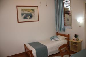 A bed or beds in a room at Medieval Rose Guest House