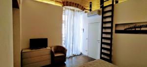 a room with a staircase and a bedroom with a television at Vien dal Mare in Bari
