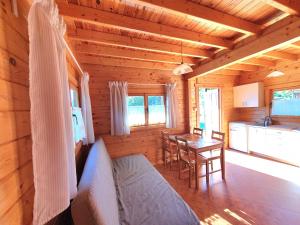 a log cabin with a bed and a table in it at Anna i Halina in Sztutowo