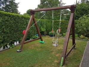 an old swing set in a yard with a yard at FERIENHAUS FISCHER in Zweibrücken
