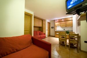 a living room with a couch and a dining room at Residence Deborah in Madesimo
