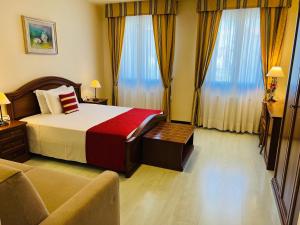 A bed or beds in a room at Albergo Italia
