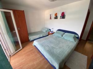 a small bedroom with a bed and a mirror at Lilac Apartments in Trogir