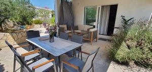 a patio with a table and chairs and a couch at Niky's in Stari Grad