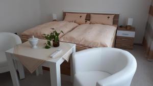 a bedroom with a bed and a table and a chair at Feriendomizil Annette`s Scholle in Sondershausen +69 photos