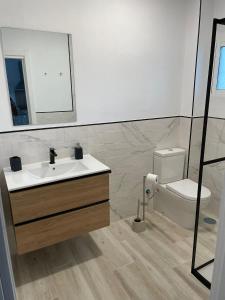 a bathroom with a sink and a toilet at Relax y sol in Torreguadiaro