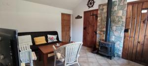 a living room with a table and a wood stove at Domki Rydzewo in Rydzewo