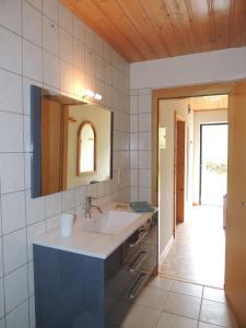 a bathroom with a sink and a mirror at Les Hauts de Brochot in Saint-Maurice-sur-Moselle
