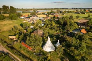 an aerial view of a village with a large tent at Slapen tussen de schapen in de Tante Tipi in Zennewijnen