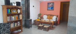 a living room with a couch and a table at Habitación casa de campo. in San Rafael