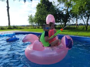 two young children riding on an inflatable at Black Horse in Pasłęk