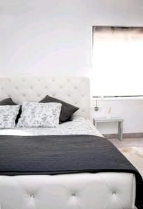 Un pat sau paturi într-o cameră la Landscape Benveniste