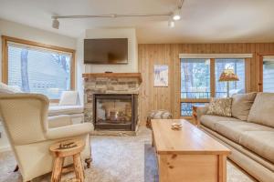 a living room with a couch and a fireplace at Ski House 155 in Bend