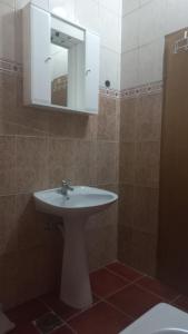 a bathroom with a white sink and a mirror at Apartments Vukasović in Kotor +27 photos