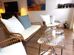 - un salon avec des chaises en osier et une table basse dans l'établissement white pearl apartment central confy spacious, à Lagos