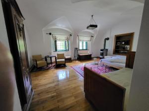a large living room with a bed and a table at Apartma 5 in Radovljica