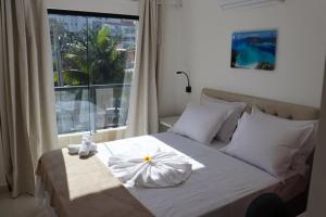 Säng eller sängar i ett rum på Pousada Areia Branca