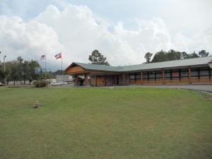 a building with two american flags in front of it at Holiday Terrace Motel in Houston