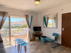 a living room with a view of a balcony at Litoral Burriana Apartments Casasol in Nerja