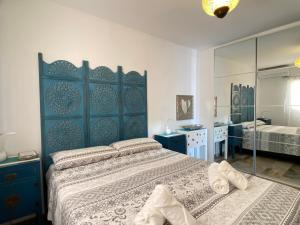 a bedroom with a large bed and a mirror at Litoral Burriana Apartments Casasol in Nerja