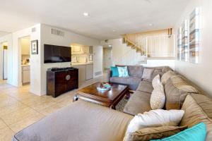 a living room with a couch and a table at Tennis on El Paseo at Sandroc Permit# STR2023-0030 in Palm Desert