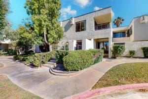 a house with bushes in front of it at Tennis on El Paseo at Sandroc Permit# STR2023-0030 in Palm Desert