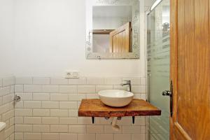 a bathroom with a bowl sink on a wooden table at LM Casa ALBAYCIN in Granada +15 photos