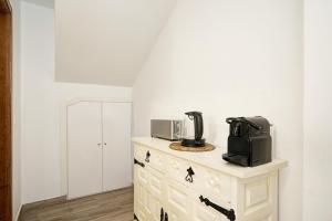 a kitchen with a microwave on top of a dresser at LM Casa ALBAYCIN in Granada