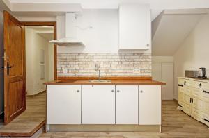 a kitchen with white cabinets and a sink at LM Casa ALBAYCIN in Granada