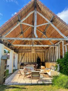 a large wooden patio with couches and a table at Gaston en Baie in Villers-sur-Authie